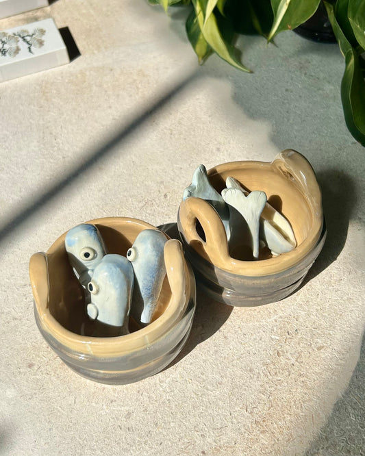 sardine spoons in a bucket